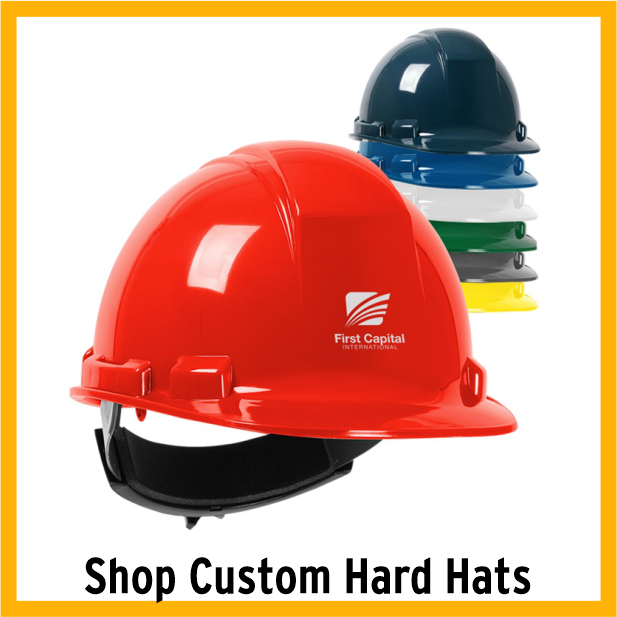 Red hard hat with stack of hard hats behind